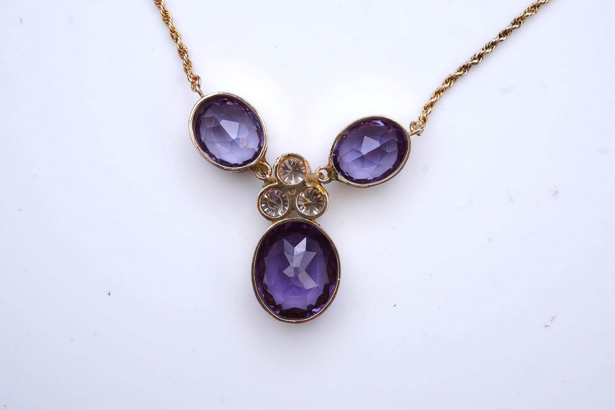 A synthetic colour-change sapphire and diamond pendant necklace
